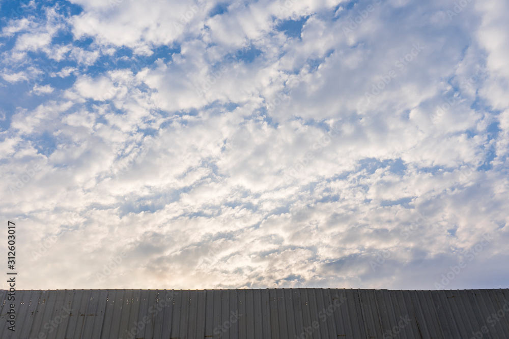 Fototapeta premium Wall with beautiful cloudy sky