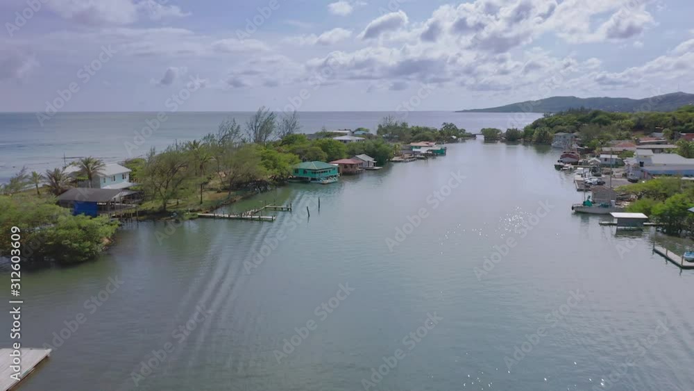 Aerial flight over water to homes built oceans edge, Oak Ridge, Roatan Aerial flight over water to homes built oceans edge, Oak Ridge, Roatan