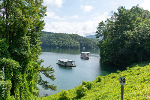House boats peek through the lush greens of the countryside along the railroad in the mountains of North Carolina.