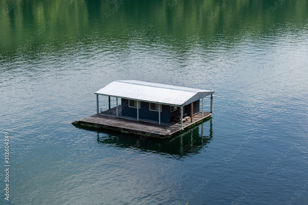 A lone house boat sits in the river along the train tracks in the North Carolina mountains. A lone house boat sits in the river along the train tracks in the North Carolina mountains.