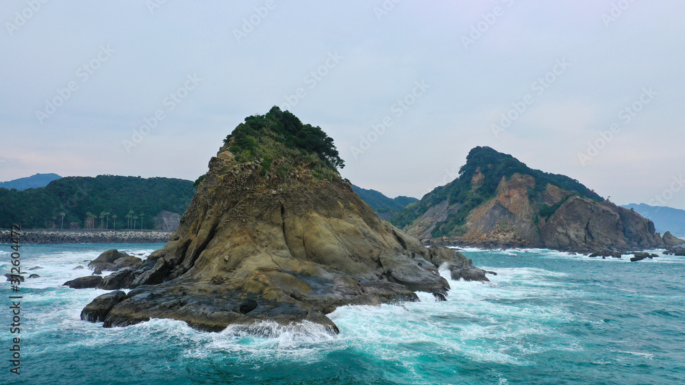 rocky islands in the pacific ocean. tropical islands of Japan, a stormy sea of ​​incredible shape cliffs in the ocean. clear turquoise blue water, sea foam