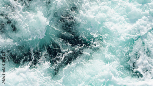 texture dark water of the deep ocean. sea ​​foam on the waves during a storm. natural composition in the ocean. aerial view, sea background. rough