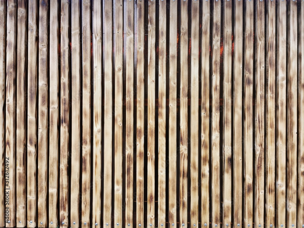 Wooden thin slats with traces of firing. Thin vertical slats.Wooden background. Abstract background. Wooden thin slats with traces of firing. Thin vertical slats.Wooden background. Abstract background.