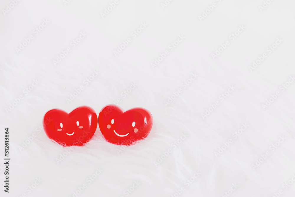 Couple red heart with a smiling face on soft white wool table background.Concept of love in the lovers of the festival of valentine day. Couple red heart with a smiling face on soft white wool table background.Concept of love in the lovers of the festival of valentine day.