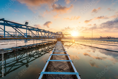 The Solid Contact Clarifier Tank type Sludge Recirculation process in Water Treatment plant with sunrise photo