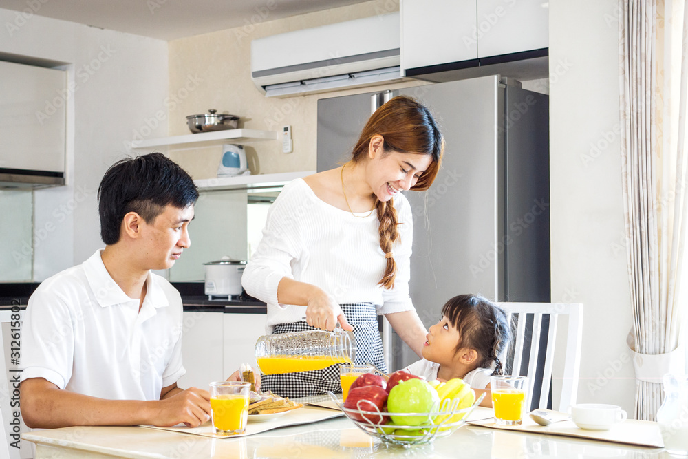portrait of Happy asian family have a breakfast in the kitchen