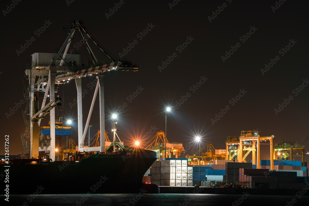 Container cargo ship in imports exports logistics business in shipyard