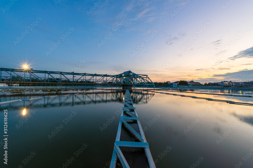 Water treatment plant with sunset