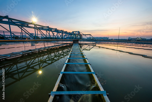 Water treatment plant with sunset. water treatment plant, ecosystem, waste water, water recycle, water purification or environment industry concept