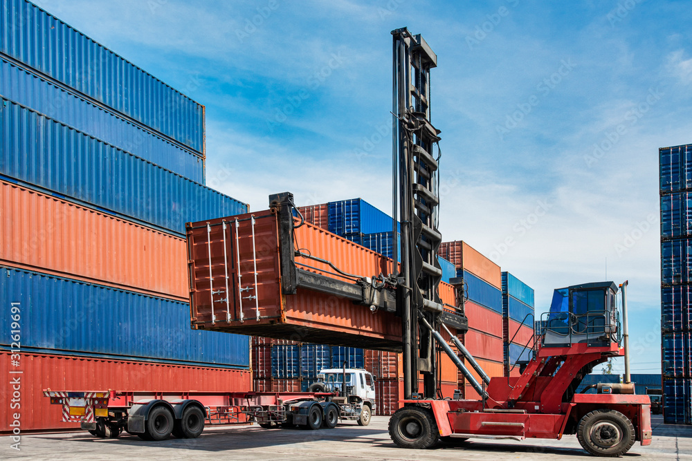 forklift loading container box from truck in imports exports logistics zone in shipyard, logistics business concept