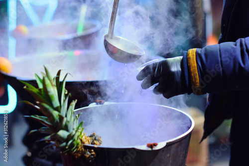 Christmas city fair. Close up view of the pot filled with the mulled wine