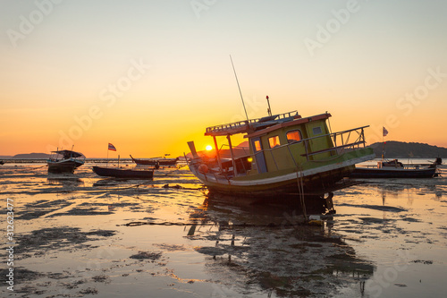 scenic reflection of beautiful sunshine in the sea fishing boats are floating in the Rawai sea