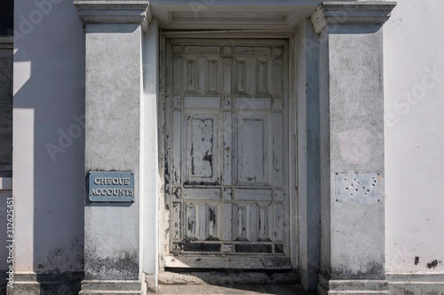 The main entrance to an abandoned bank building, with a 