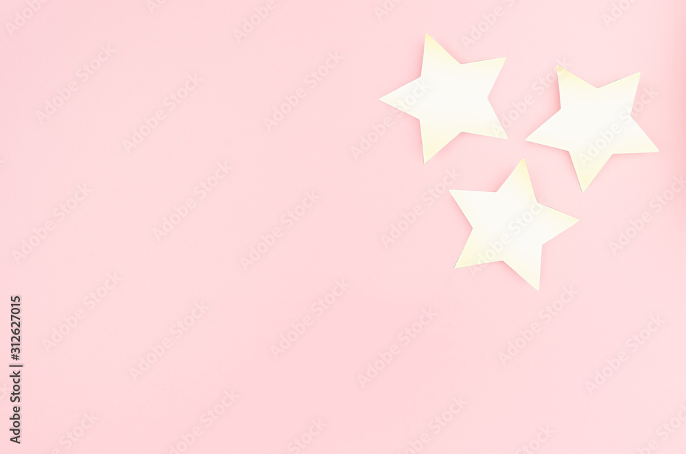 New Year modern stylish background- golden stars on pastel pink color, top view, copy space. New Year modern stylish background- golden stars on pastel pink color, top view, copy space.