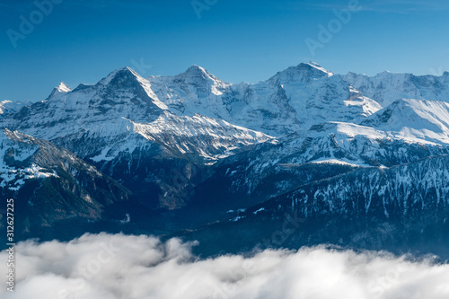 Eiger M  nch and Jungfrau in winter above the fog