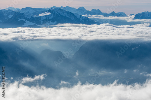 layer of clouds with tyndall effect at the flank of Mount Niesen at the entrance of Simmental Valley