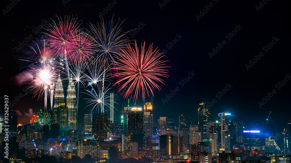 Firework display on Kuala Lumpur city with text happy new year 2020 Firework display on Kuala Lumpur city with text happy new year 2020