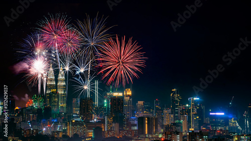 Firework display on Kuala Lumpur city with text happy new year 2020 © jasniulak