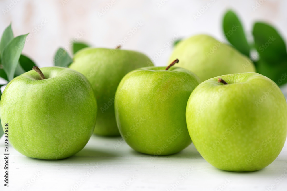 Green apples on white wooden table. Fresh green granny smith apples, juicy fruits Green apples on white wooden table. Fresh green granny smith apples, juicy fruits