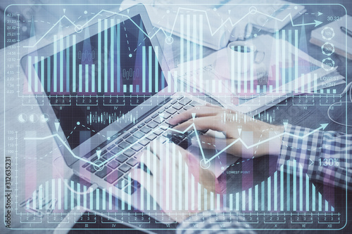 Double exposure of forex graph with man working on computer on background. Concept of market analysis. © peshkova
