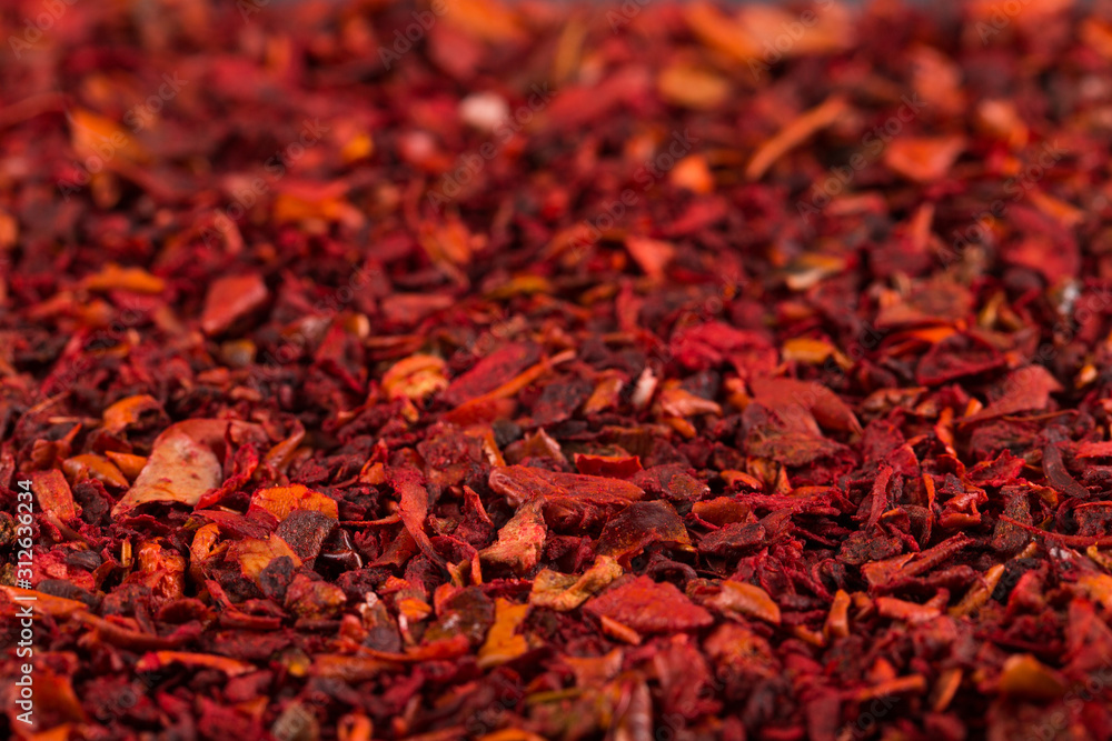 Fototapeta premium Crushed pepper, red background of spices. Copy space.