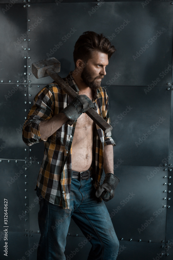Brutal bearded man in a plaid shirt