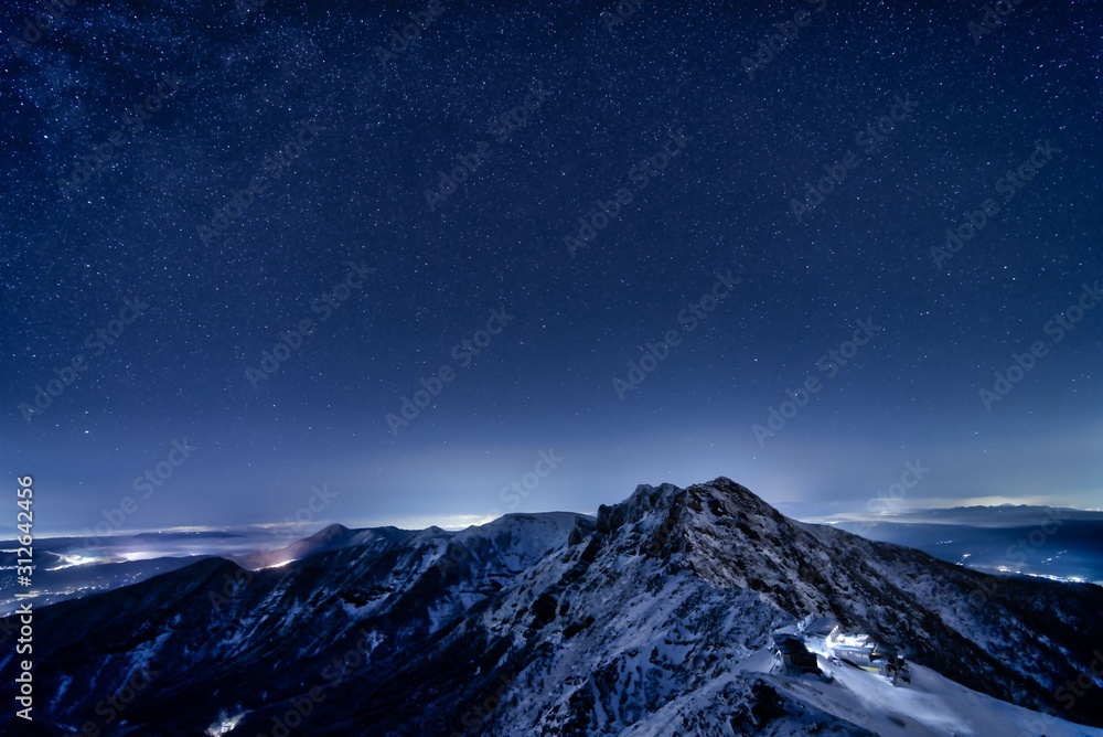 Yatsugatake Mountains covered with smow and starry sky in Winter, Nagano prefecture, Japan