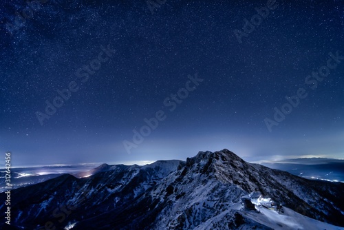 Yatsugatake Mountains covered with smow and starry sky in Winter, Nagano prefecture, Japan