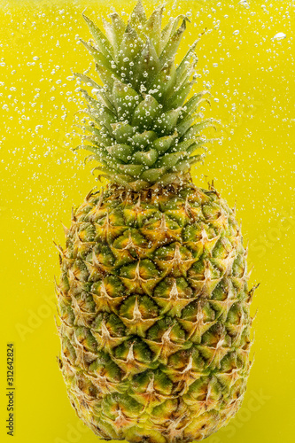pineapple under water with bubbles and bubbles on a yellow background