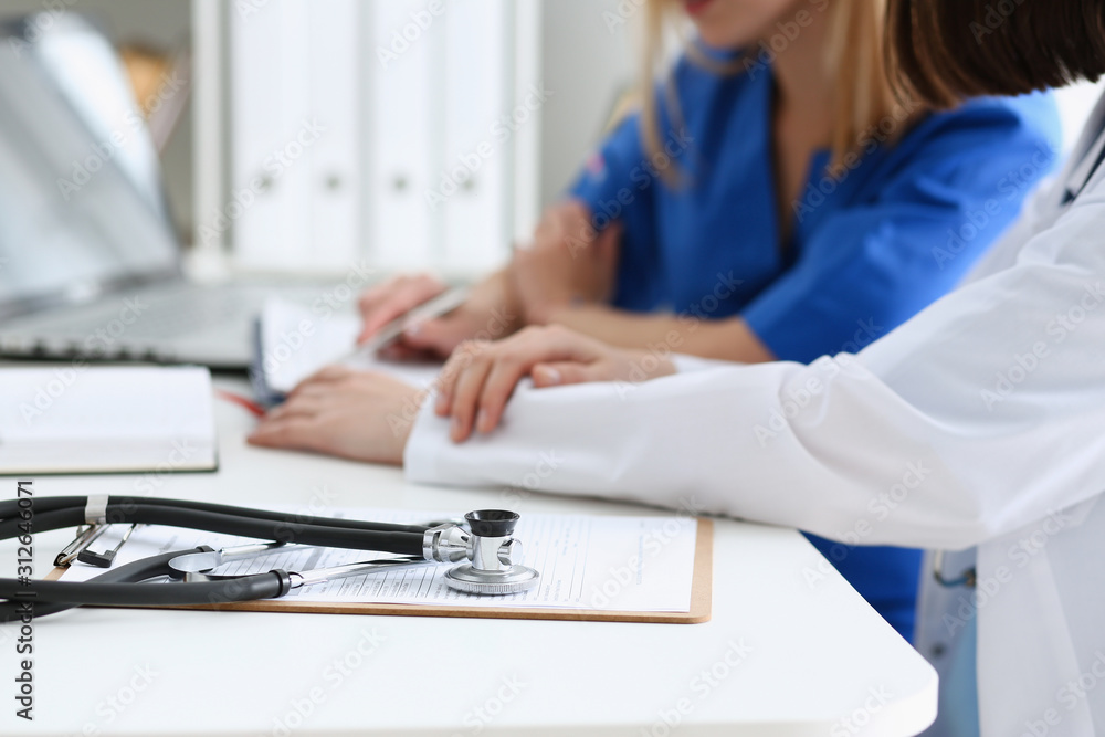 Fototapeta premium Stethoscope head lying on medical forms