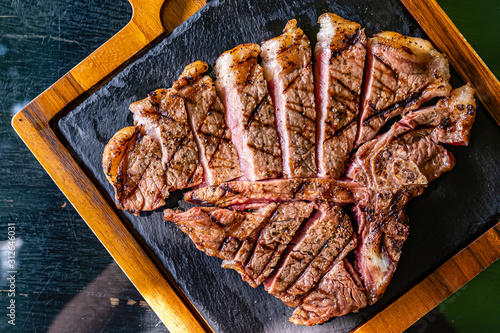 T-bone steak on the wooden plate