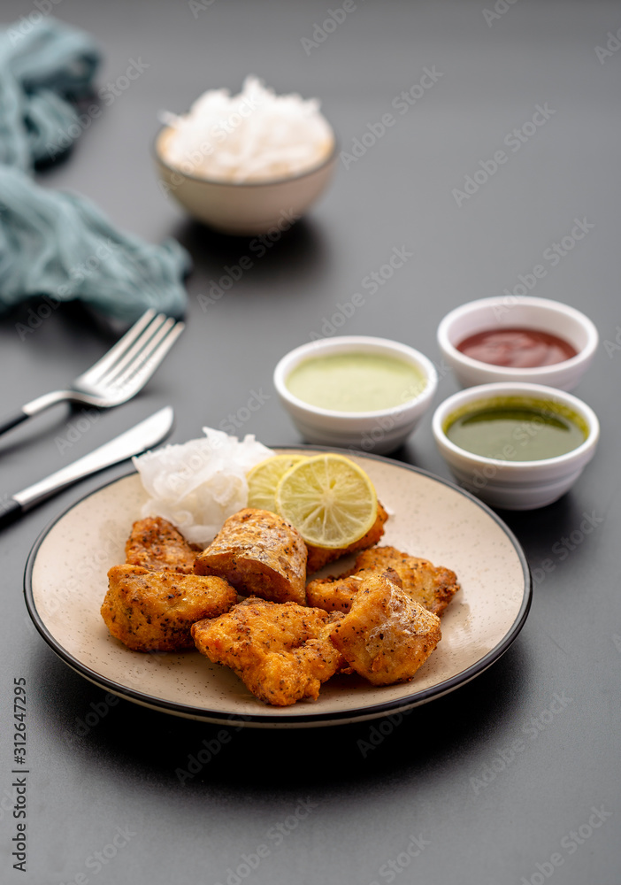 Boneless fried fish served with green sauce and dip Boneless fried fish served with green sauce and dip