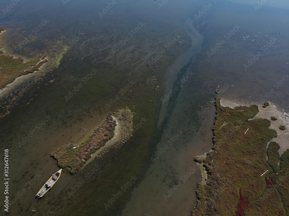 Aerial overhead photo from a drone over a swamp on the delta of Axios river in Thessaloniki/Greece that washes unto the Mediterranean sea Aerial overhead photo from a drone over a swamp on the delta of Axios river in Thessaloniki/Greece that washes unto the Mediterranean sea