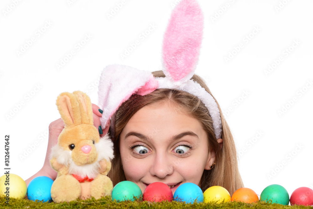 Surprised girl wear bunny ears on Easter day. Young woman with painted eggs on green grass, spring. Happy Easter concept. Cute girl with decorated easter eggs isolated at white background. Surprised girl wear bunny ears on Easter day. Young woman with painted eggs on green grass, spring. Happy Easter concept. Cute girl with decorated easter eggs isolated at white background.