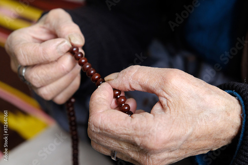 muslim old woman is worshiping with rosary, old woman and rosary in hand,