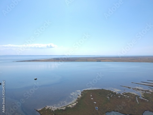 Aerial overhead photo from a drone over a swamp on the delta of Axios river in Thessaloniki/Greece  that washes unto the Mediterranean sea photo