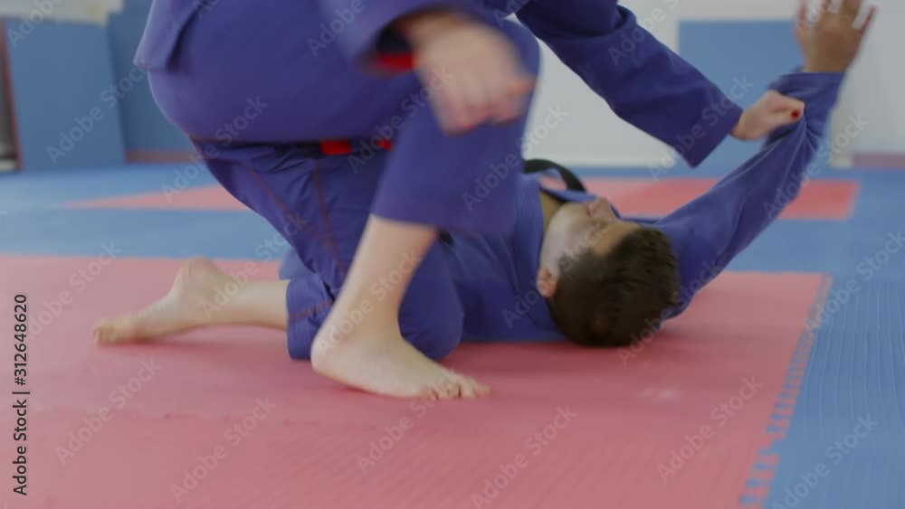 Video Stock Tilt down shot of caucasian female jiujitsu fighter