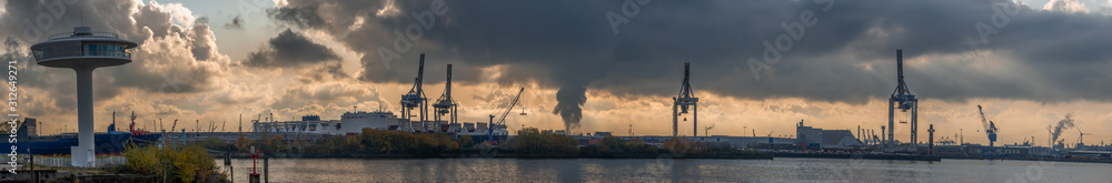 Panoramic view of port of Hamburg from Hafencity during sunset with dramatic stormy clouds