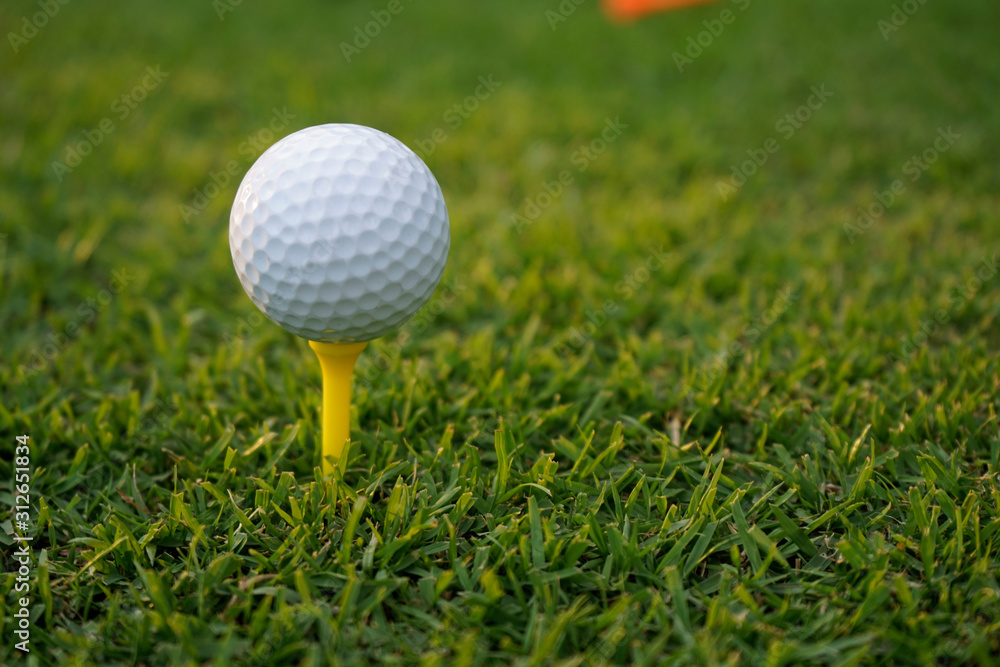 Golf ball on tee in beautiful golf course at sunset background. Golf ball on tee in beautiful golf course at sunset background.