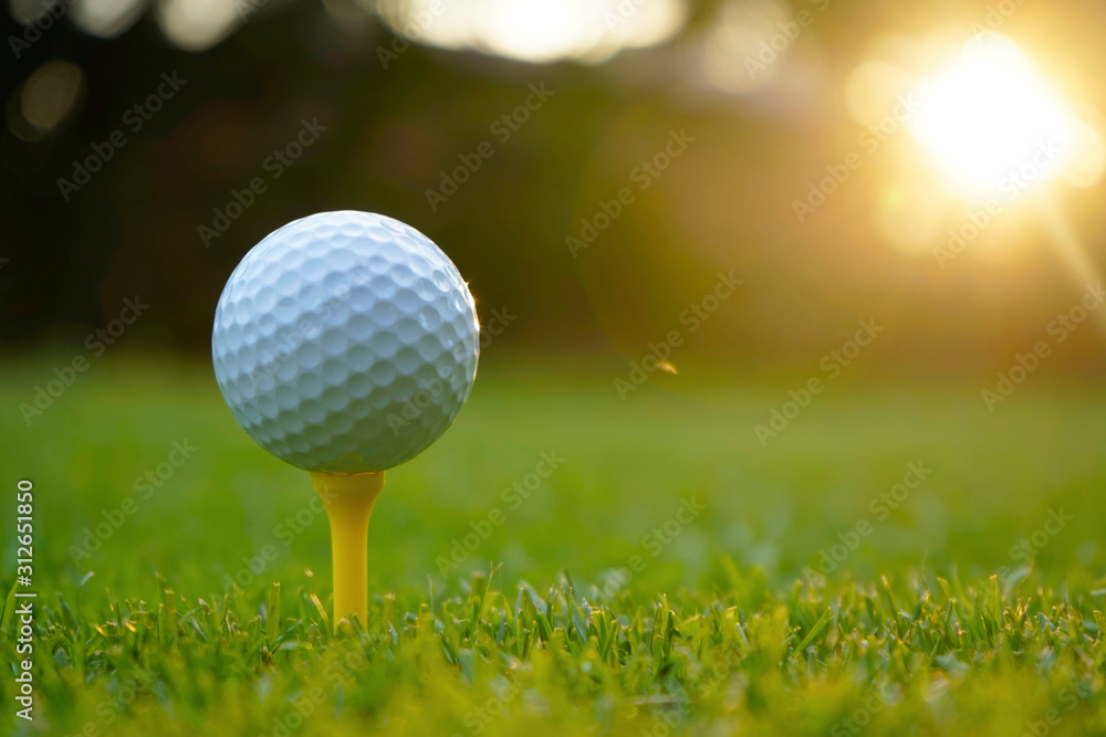 Golf ball on tee in beautiful golf course at sunset background. Golf ball on tee in beautiful golf course at sunset background.