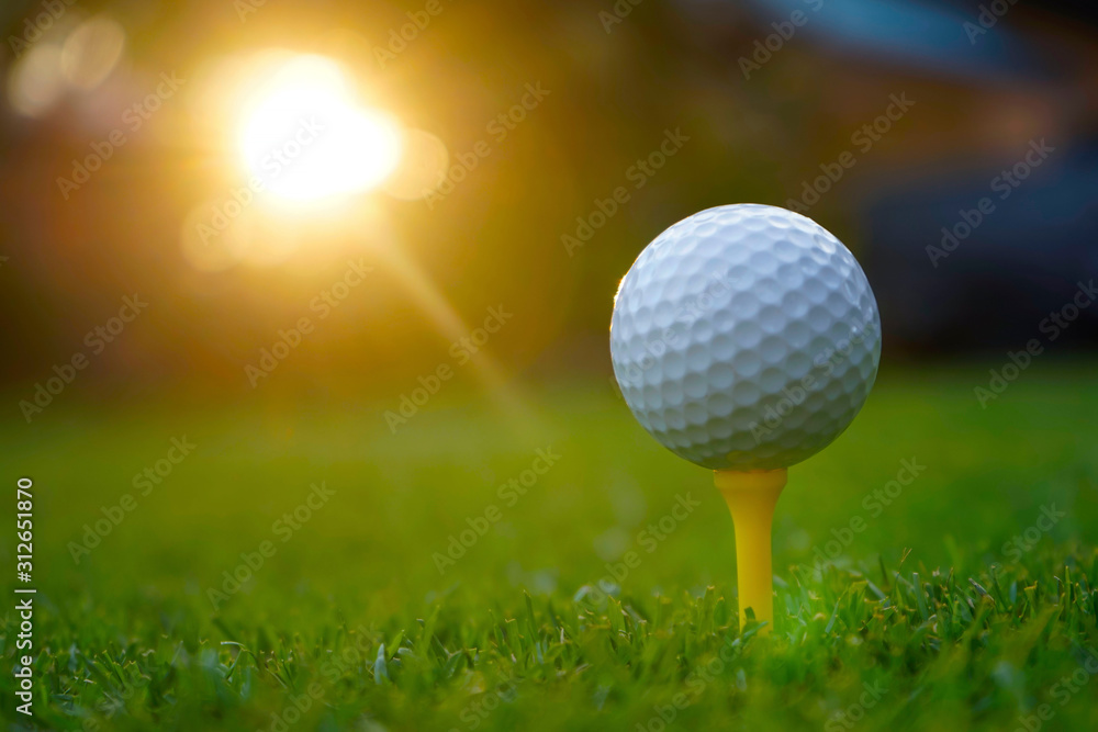 Golf ball on tee in beautiful golf course at sunset background. Golf ball on tee in beautiful golf course at sunset background.