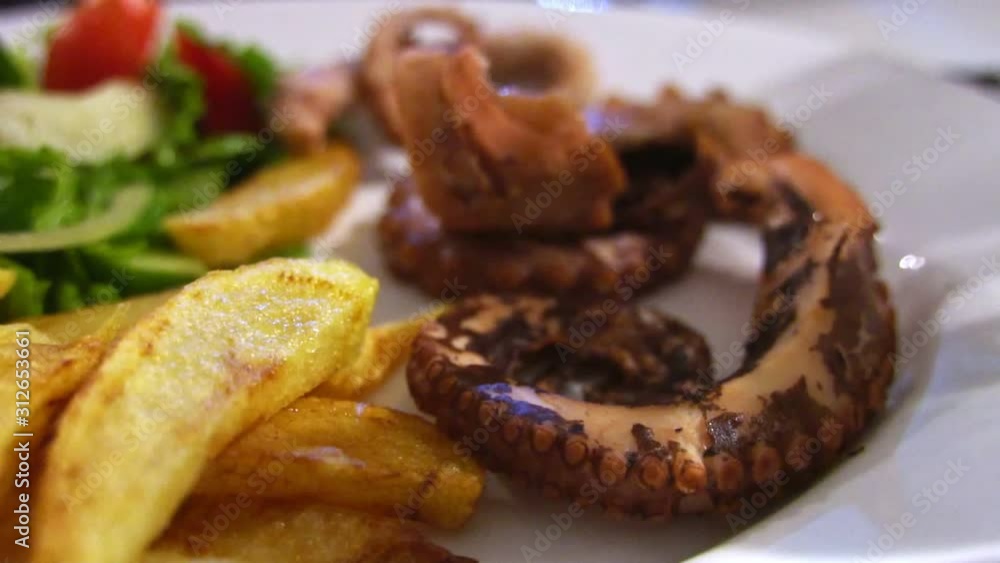 Grilled octopus with french fries. Grilled octopus with french fries.