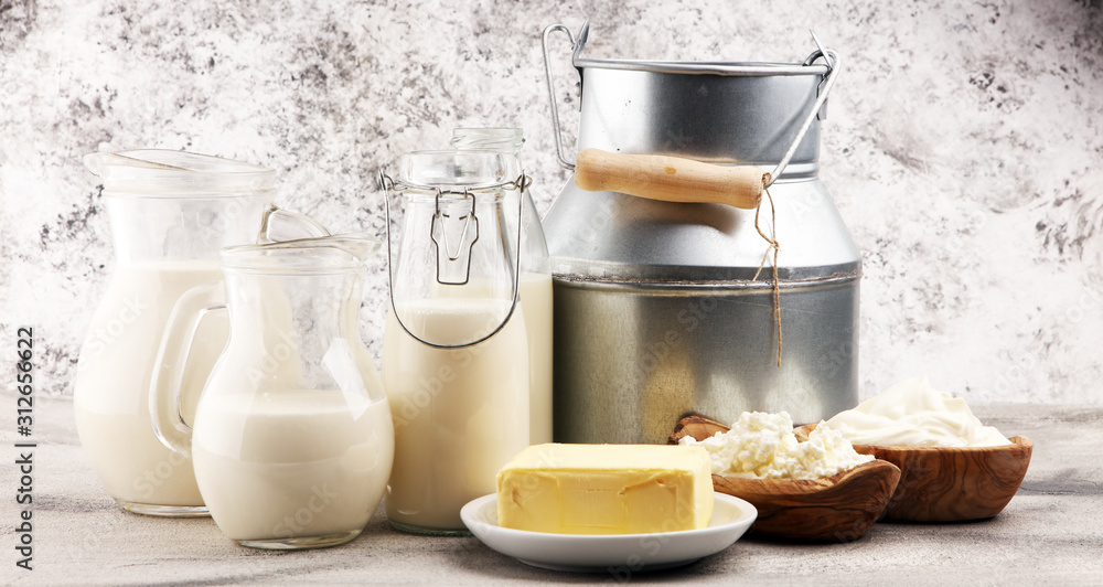 Different healthy dairy products on rustic background with milk, cheese, butter and cottage Different healthy dairy products on rustic background with milk, cheese, butter and cottage