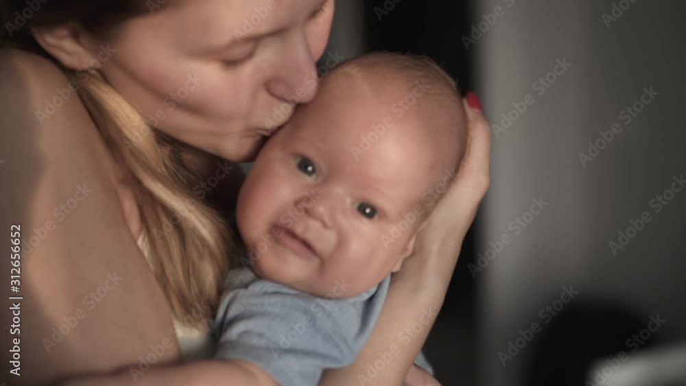 Happy mother hugging newborn baby and amusing with love Happy mother hugging newborn baby and amusing with love