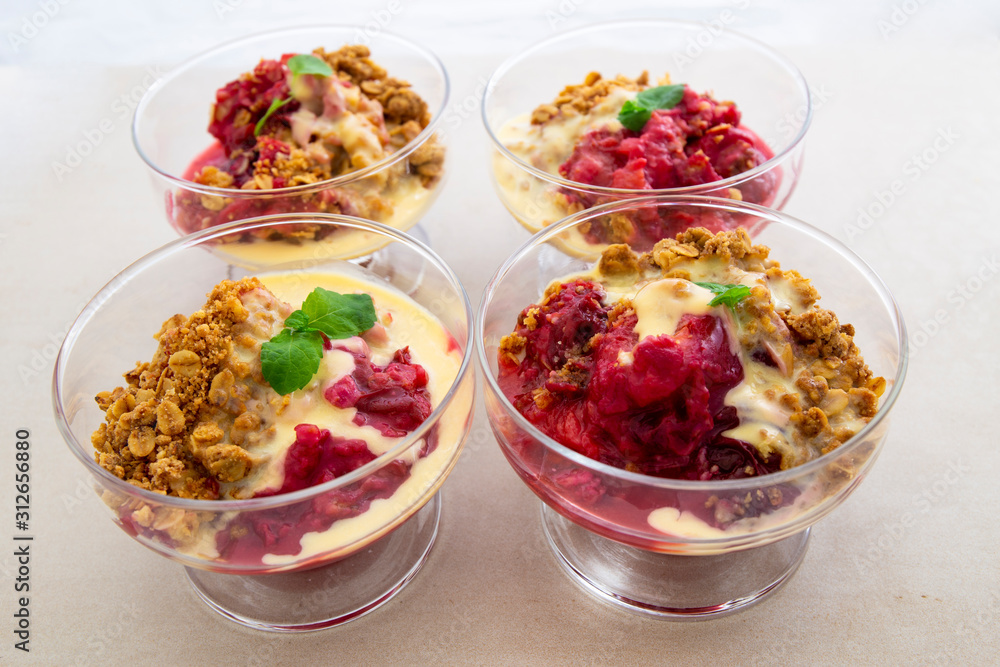 Fresh bright red plum crumble in the dessert bowl Fresh bright red plum crumble in the dessert bowl