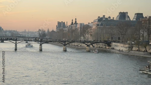 View towards Pont des Arts on the river Seine as a cruise ship passes under it, Paris, France