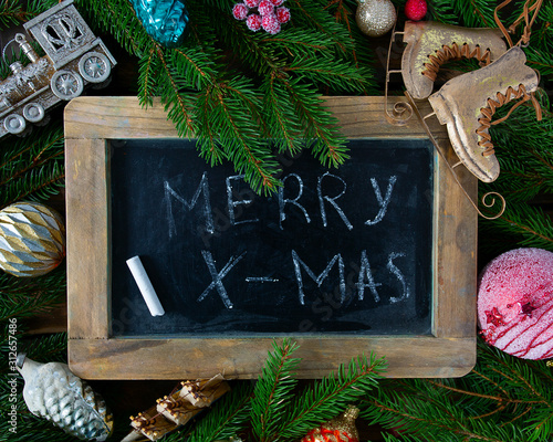 Christmas decoration and 'merry x-mas' on chalkboard photo