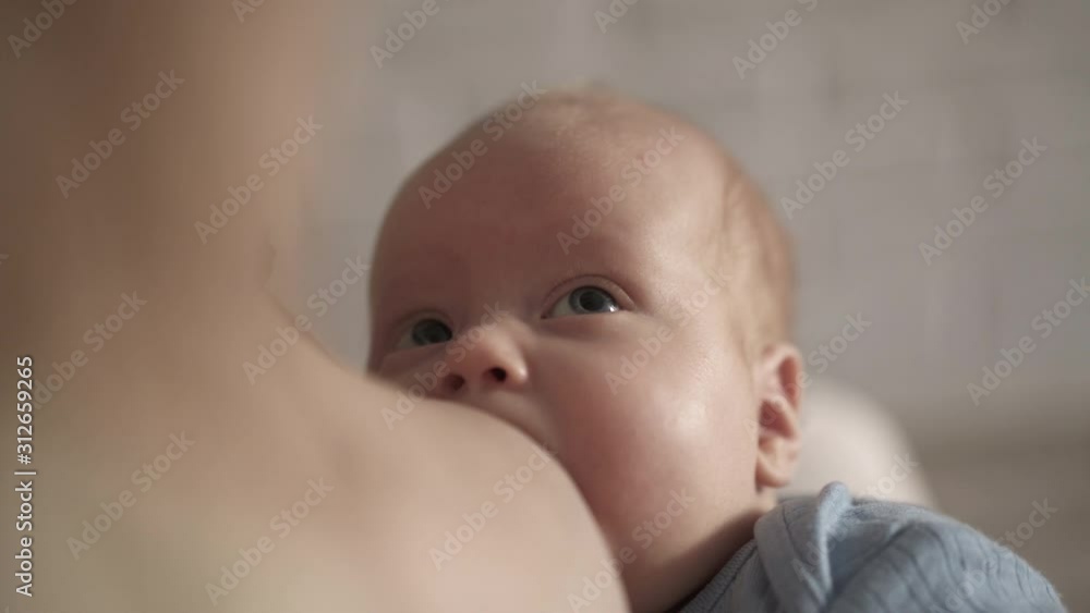 Close portrait of feeding newborn baby looking on mother. 4K Close portrait of feeding newborn baby looking on mother. 4K