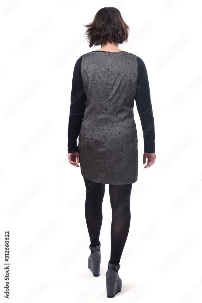 rear view of middle-aged woman with a dress on white background, walking on white rear view of middle-aged woman with a dress on white background, walking on white