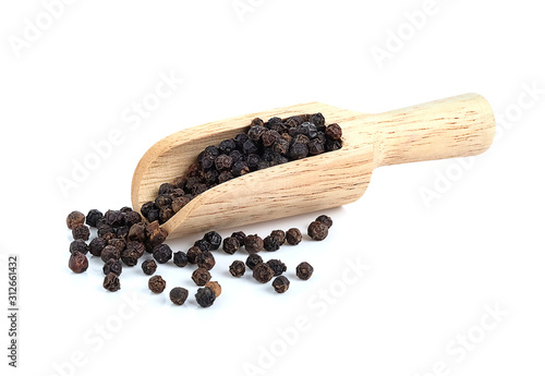 Black pepper with wooden scoop on white background